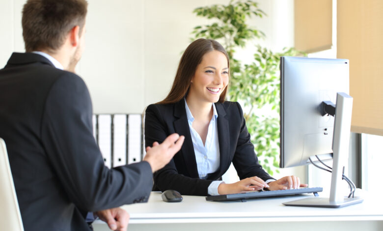 salesperson behind desk with customer