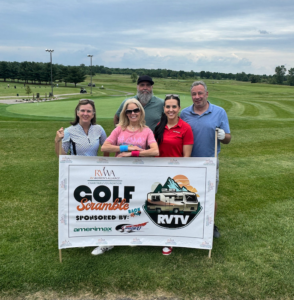 5 people standing behind a sign for the RV Women's Alliance inagural Golf Outing.