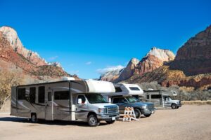 Buying an RV at Auction: What Dealers & Private Buyers Should Know 5 RVs in a parking lot at the campsite at Zion National Park, Arizona, USA