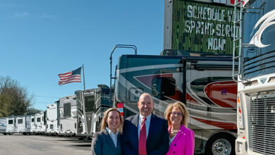Three people (Lexi, Frank and Suzanne Roberts, left to right) pictured in front of Long View RVs.