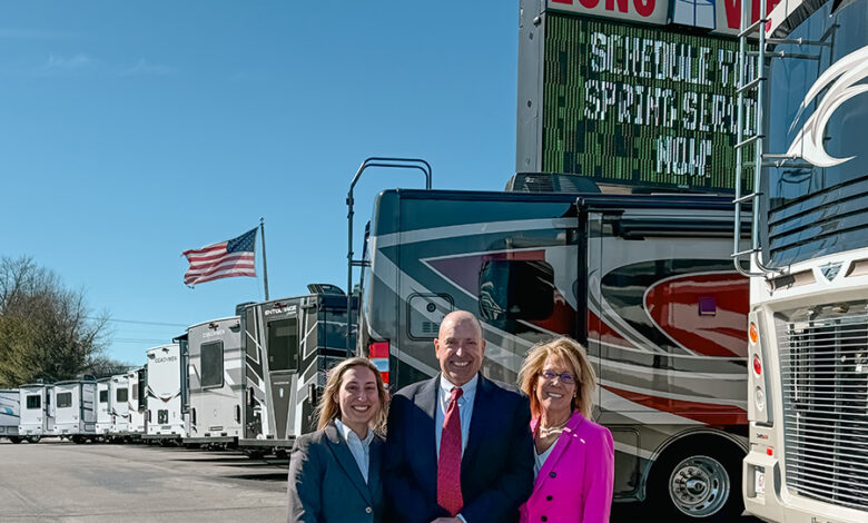 Three people (Lexi, Frank and Suzanne Roberts, left to right) pictured in front of Long View RVs.