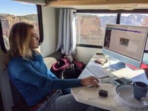 Influencer Marketing Produces Road-Tested Results 3 A person working on a laptop inside an RV working on influencer content creation.