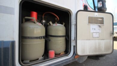 Gas cylinder tanks pictured in a motorhome to illustrate an RV's propane system.