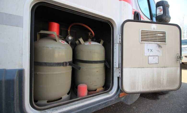 Gas cylinder tanks pictured in a motorhome to illustrate an RV's propane system.