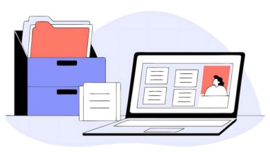 Files in a file box and a laptop open on a desk to demonstrate using dealership management systems (DMS).