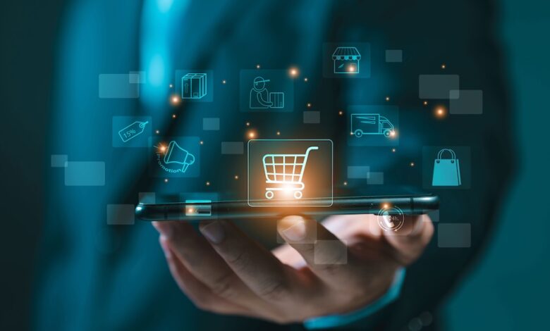 Why RV Dealers Need Digital F&I 2 To illustrate finance and insurance, an image of a man's hand outstretched holding a table with glowing graphics of a shopping cart and other shopping images floating above it.