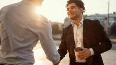 Two men shaking hands to demonstrate a salesperson meeting a customer and making a good first impression.