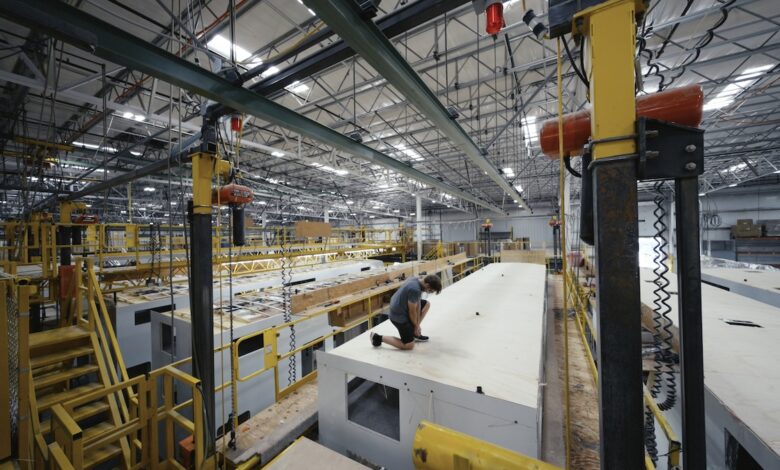 Heartland RV Renews Focus on Quality & Dealer Relationships 1 A man on the roof of an RV in an industrial setting, demonstrating the production of Heartland RVs now under the Jayco umbrella.