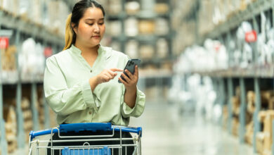 A woman in an aisle of a store pushing a cart down an aisle, illustrating people seeing their store from a shopper's point of view.