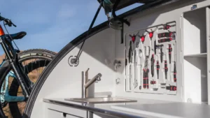 Small but Mighty: Escapod’s Off-Road Teardrop Camper 4 An image of the TOPO2 MTB galley at the rear, which has tools inset into the cabinet to both secure them and save space.