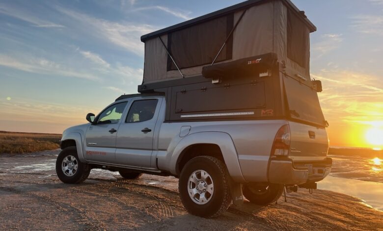 Custom Trailer Tents & Shelters for Outdoor Enthusiasts 1 A PahaQue Custom Inc. tent on the top of a truck camper with a sunset background.