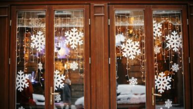 Christmas lights and snowflakes in a wooden window store front to demonstrate merchandising for RV winterization products.