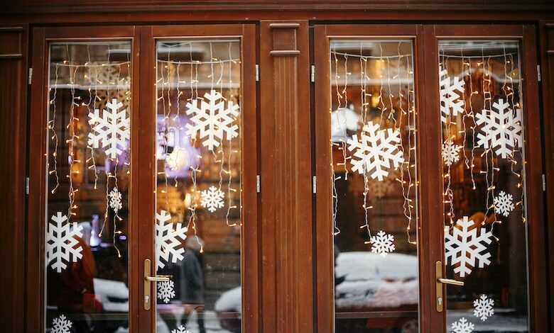 Christmas lights and snowflakes in a wooden window store front to demonstrate merchandising for RV winterization products.