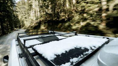 Snow on RV rooftop solar panels to illustrate the importance of solar maintenance.