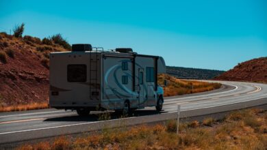 RV on roadway with blue sky above, demonstrating transporting RVs