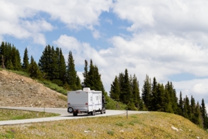 View from the top of Cottonwood Pass, Colorado, of an RV on a road