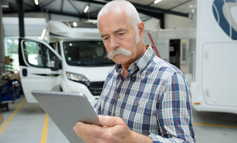 lightspeed senior man looking at tablet in motorhome garageUntitled