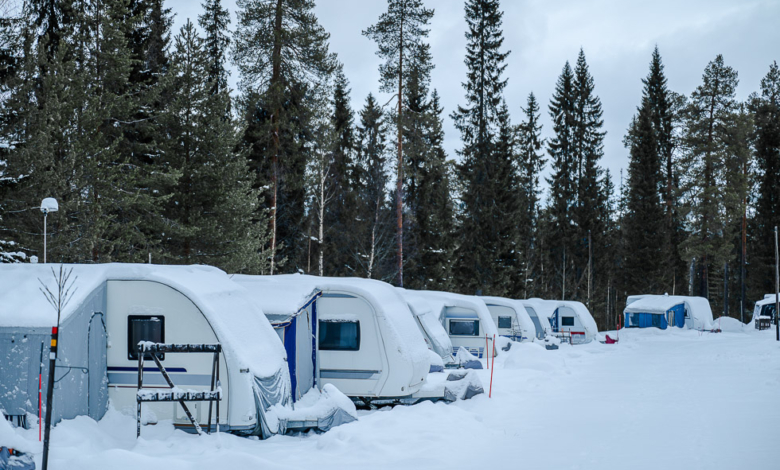 Caravan of camper cars in winter forest. Camping in Lapland Finland. Winter camping concept